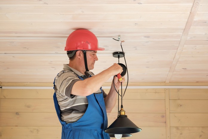 Tools and safety gear prepared on a table for light fixture installation